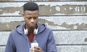 teen with headphones around neck