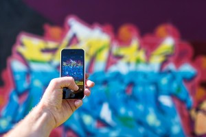 phone taking photo of graffiti wall